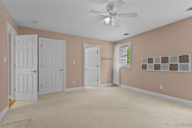 unfurnished bedroom featuring ceiling fan and light carpet