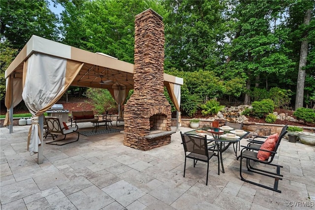 view of patio featuring an outdoor living space with a fireplace