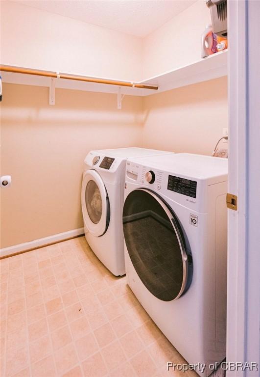 clothes washing area featuring separate washer and dryer