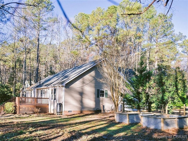 view of side of home with a wooden deck