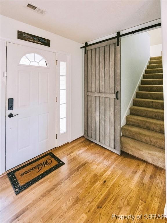 entrance foyer with hardwood / wood-style flooring and a barn door