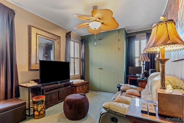 carpeted living room with ceiling fan and ornamental molding