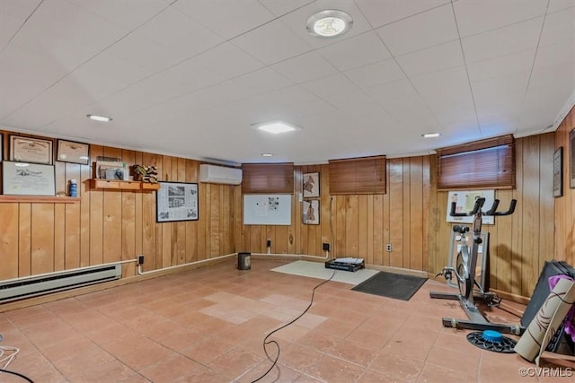 exercise area with a wall unit AC, a baseboard heating unit, and wood walls