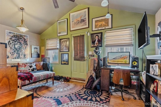 living area featuring ceiling fan, lofted ceiling, and light wood-type flooring