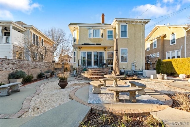 rear view of property featuring a patio area and central air condition unit