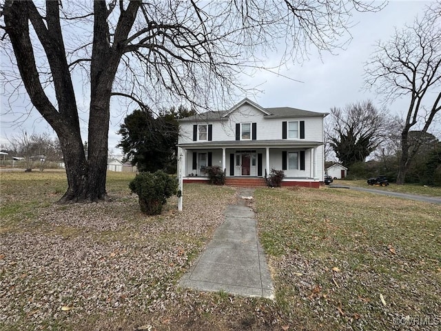 view of front facade featuring covered porch and a front yard