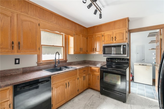 kitchen featuring black appliances, sink, and track lighting