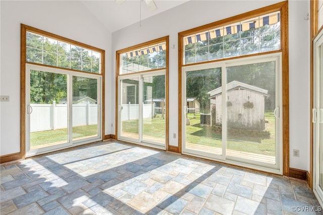 entryway with ceiling fan and high vaulted ceiling