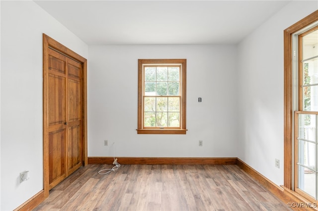 spare room with light hardwood / wood-style flooring