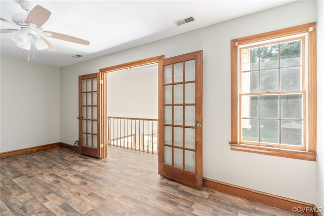 unfurnished room with french doors, ceiling fan, and hardwood / wood-style floors