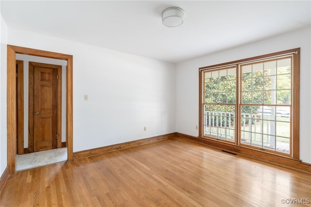 spare room with light hardwood / wood-style flooring