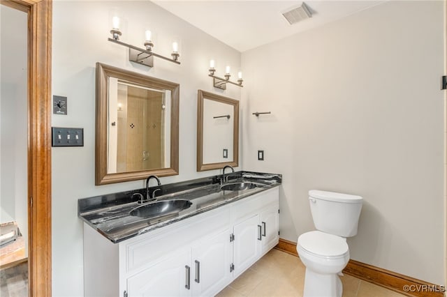 bathroom with tile patterned flooring, vanity, and toilet