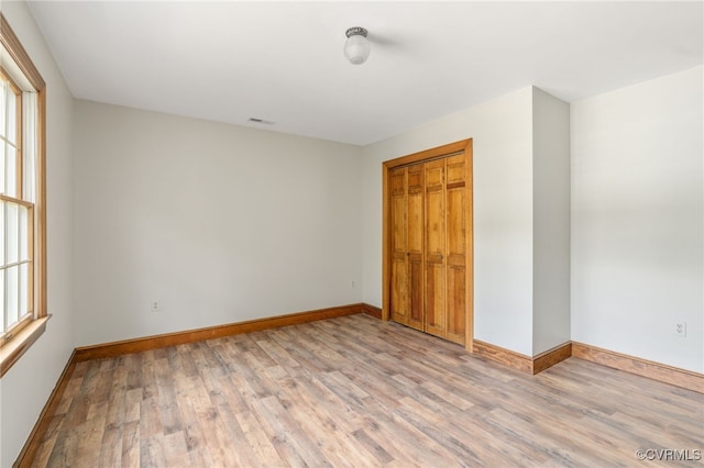 empty room with light hardwood / wood-style flooring