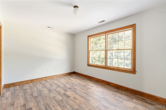 unfurnished room with wood-type flooring