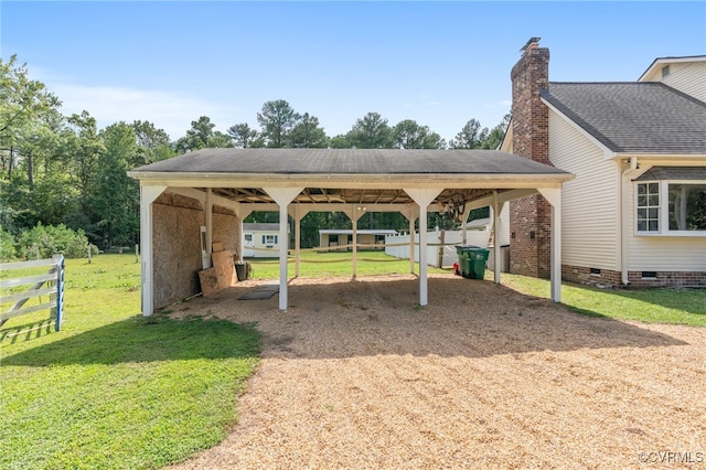 exterior space with a lawn and a carport