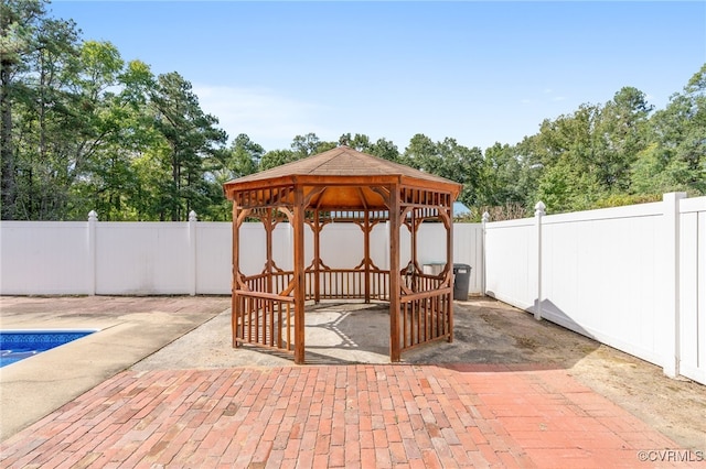 view of patio featuring a gazebo and a covered pool