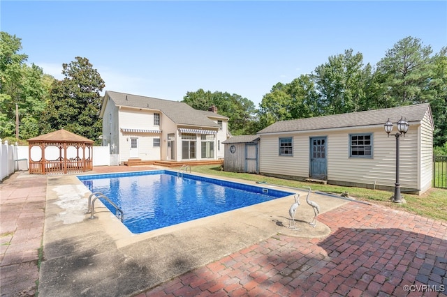 view of pool featuring a gazebo, a patio area, and an outdoor structure