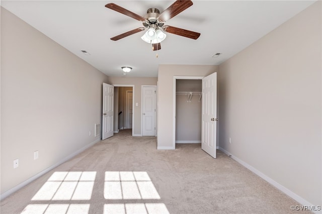 unfurnished bedroom with ceiling fan, light carpet, and a closet