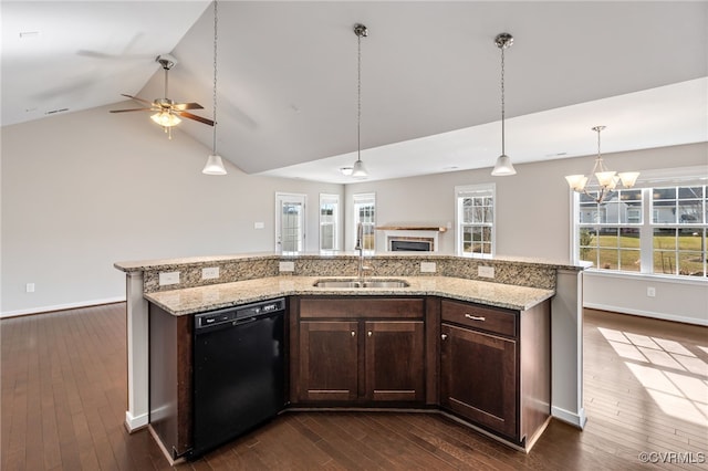 kitchen featuring an island with sink, dishwasher, plenty of natural light, and sink