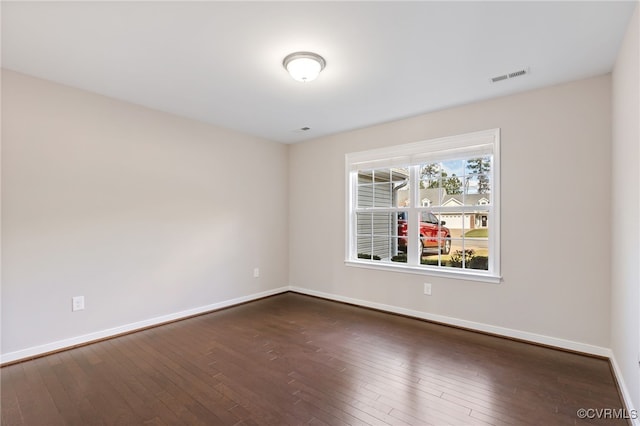 empty room with dark hardwood / wood-style floors