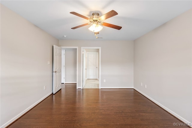 unfurnished room featuring ceiling fan and dark wood-type flooring