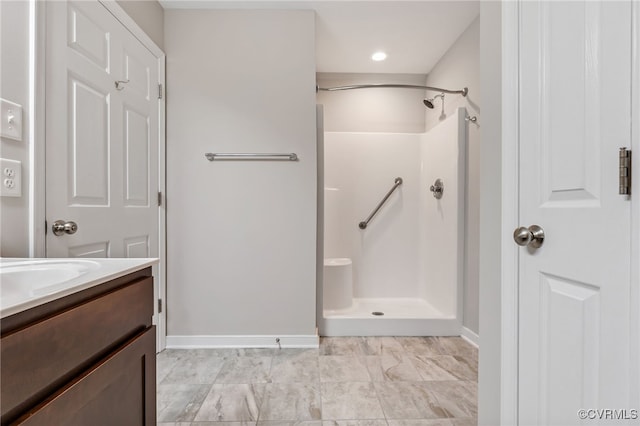 bathroom with a shower and vanity