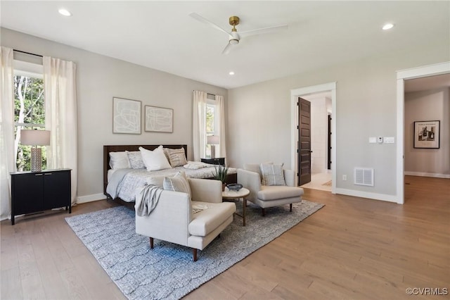 bedroom with multiple windows, light wood-type flooring, and ceiling fan