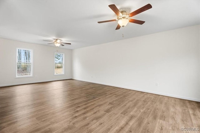 spare room featuring ceiling fan and light hardwood / wood-style flooring