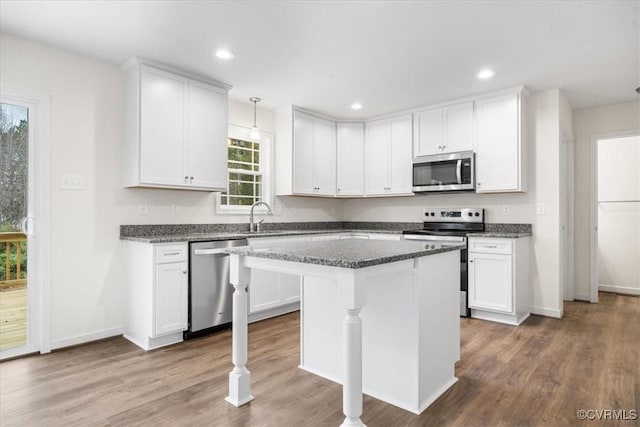 kitchen featuring white cabinets, appliances with stainless steel finishes, and a center island