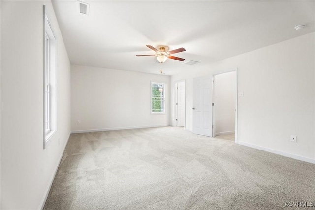 spare room featuring ceiling fan and light carpet