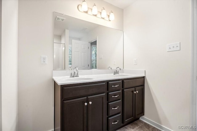 bathroom with vanity and a shower with shower door