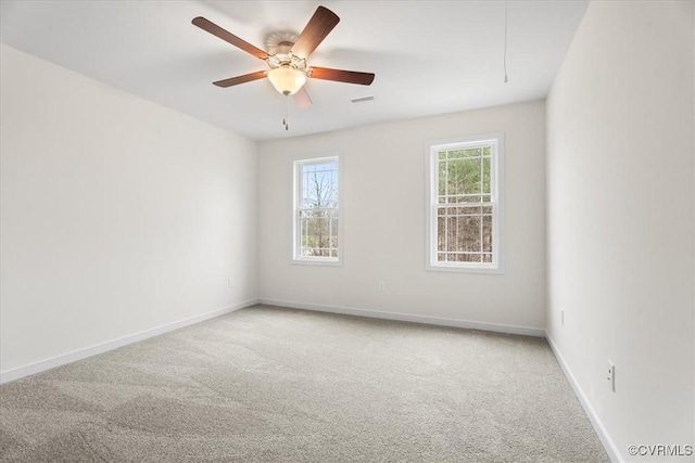 carpeted empty room featuring ceiling fan