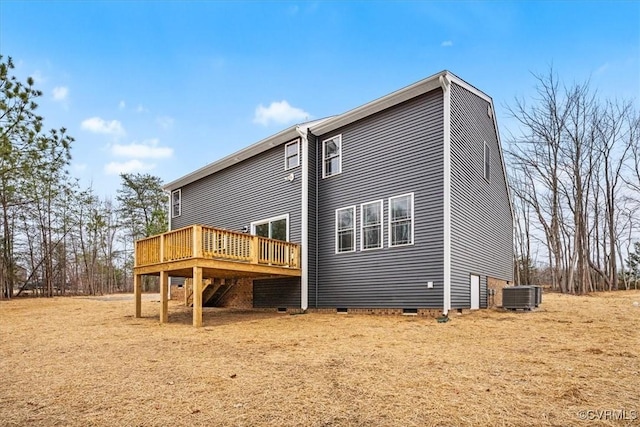 rear view of house with central AC unit and a deck