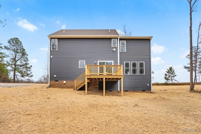 rear view of property featuring a wooden deck