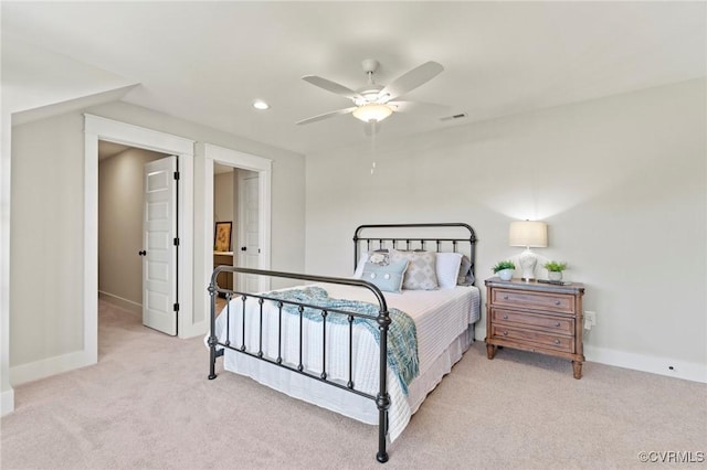 bedroom with ceiling fan and light carpet