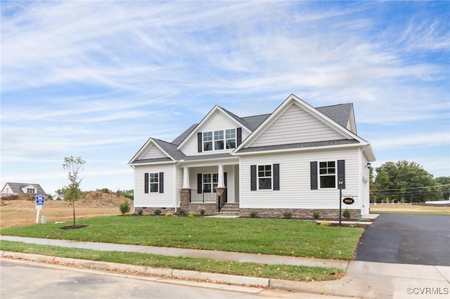 craftsman-style house with a porch and a front lawn