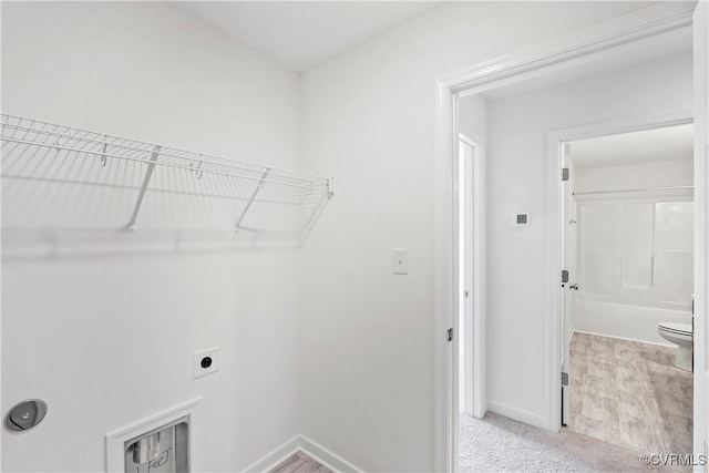 clothes washing area with light carpet and electric dryer hookup