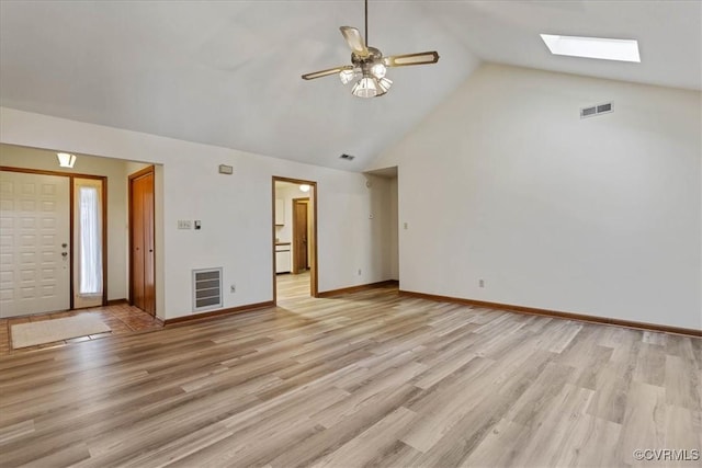 interior space with ceiling fan, light hardwood / wood-style floors, and lofted ceiling with skylight