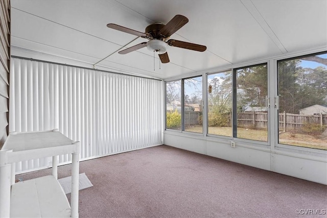 unfurnished sunroom featuring ceiling fan