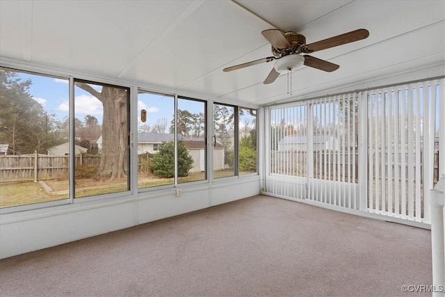 unfurnished sunroom with ceiling fan