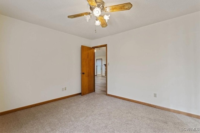 unfurnished room featuring ceiling fan and carpet floors