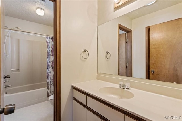 full bathroom with vanity, toilet, a textured ceiling, and shower / tub combo