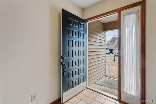 entryway with light tile patterned flooring