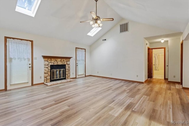 unfurnished living room with ceiling fan, light hardwood / wood-style floors, a fireplace, and vaulted ceiling