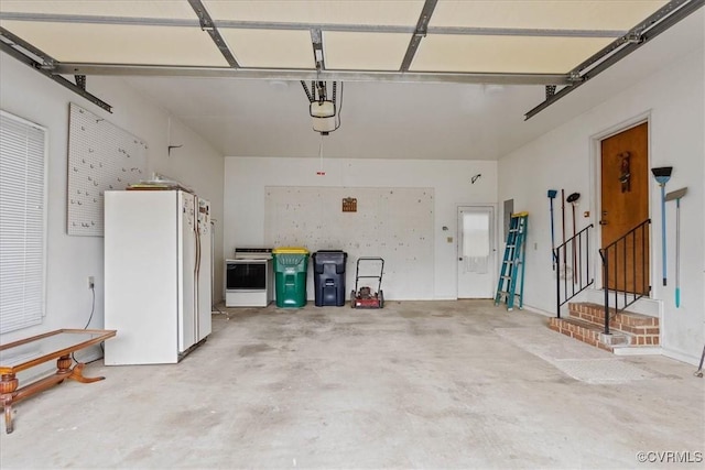 garage with white refrigerator and a garage door opener