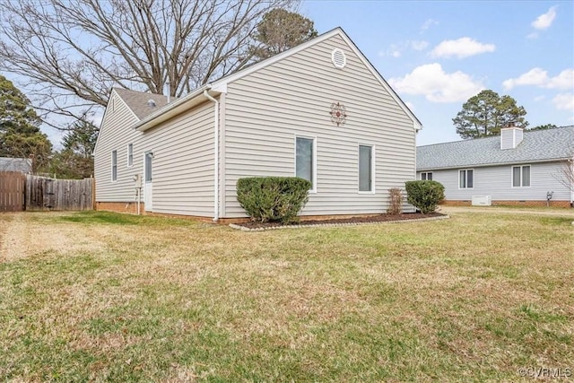 view of side of home featuring a yard