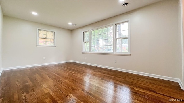 empty room featuring dark hardwood / wood-style flooring