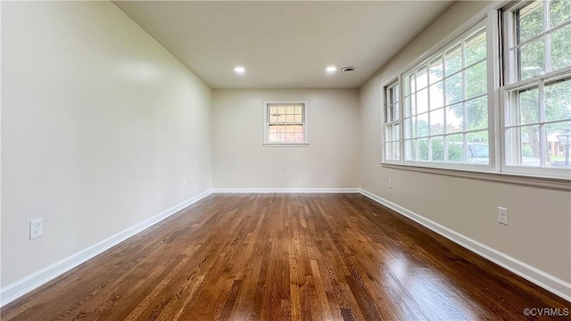 spare room featuring dark hardwood / wood-style floors