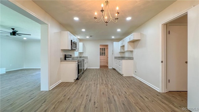 kitchen featuring ceiling fan with notable chandelier, stainless steel appliances, sink, light hardwood / wood-style floors, and white cabinetry