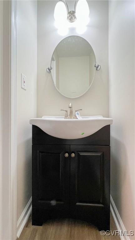 bathroom with hardwood / wood-style floors and vanity